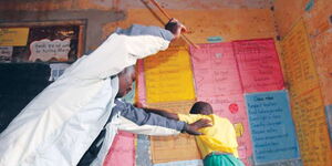 File Photo of a teacher caning a student in class