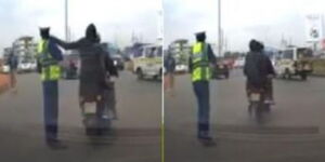 A screenshot of a pillion passenger stealing a mobile phone from a traffic police officer