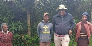 President Uhuru Kenyatta (center) takes a photo with Eunice Wanjiku (far left) and her daughter Esther Nyambura (right) at a village in Gakoe, Kiambu County.