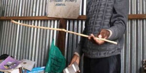 Gathungo Primary School head teacher Joseph Karume holds a cane during class session at a school in Kieni, Nyeri County, on January 21, 2016