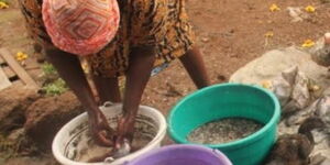 An undated file image of Debora Amimo scaling fish.