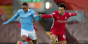 Manchester City forward Raheem Sterling (left) dribbles past Liverpool's Trent Alexander-Arnold.