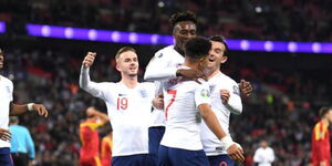 England team celebrating after scoring a goal.