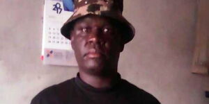 Benson Imbatu, a police officer attached to the Kabete police station,  poses for a photo.