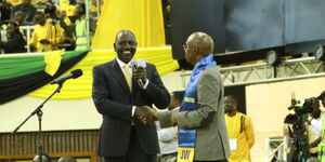 Deputy President William Ruto (left) shakes hands with Safina Presidential aspirant Jimi Wanjigi on Tuesday, March 15 at Kasarani grounds. 