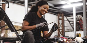 Esther Wairimu helps convert a fuel-powered vehicle to an electric-powered machine