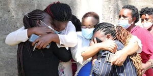 Grieving relatives at the homestead where their five family members were murdered.