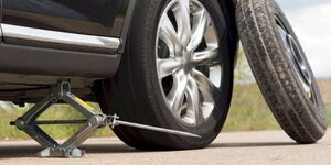 An image of a vehicle and a spare (donut) tyre.