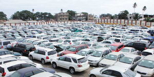 Cars at a yard awaiting auction.