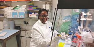 Catherine Kibirige poses for the camera while in a medical laboratory.