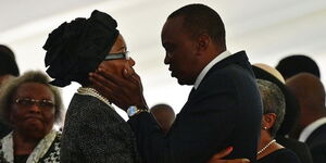 President Uhuru Kenyatta comforts Catherine Mwangi the mother of his nephew Mbugua Mwangi who was killed in a terrorist attack in Westgate Mall. 