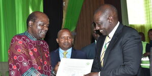 Deputy President William Ruto (right) receives the certificate of nomination to vie for the presidency from IEBC Chairperson Wafula Chebukati at the Bomas of Kenya on Saturday, June 4, 2022