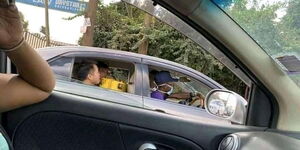 A Kenyan taxi driver ferrying Chinese passengers in a photo that surfaced on Thursday, February 27, 2020.