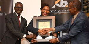 Co-op Bank Head of Digital Payment Services Chris Cheruiyot and the Head of Customer Experience Rose Nyamweya receive the certificate of Overall Winner of the Customer Satisfaction awards of the Kenya Bankers’ Association (KBA) from the Communications and Public Affairs Director of KBA Fidelis M. Muia.