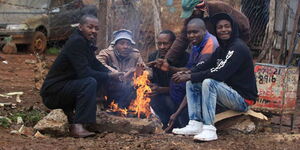 A file image of Nairobi resident seated next to a bonfire.