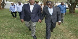 President Uhuru Kenyatta and Igembe South MP John Paul Mwirigi take a walk after Sagana Lodge meeting in 2017.