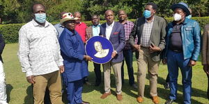 Cotu secretary general Francis Atwoli (Second from Left) hands Baringo Senator Gideon Moi a special plaque on August 1, 2020.