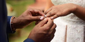 A couple exchanges rings during a wedding