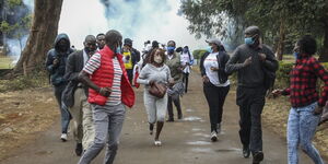 Covid-19 corruption protesters fleeing from tear gas fumes on August 21, 2020.