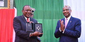President Uhuru Kenyatta and Central Bank Governor Patrick Njoroge during the launch of the new generation coins on December 11, 2018.