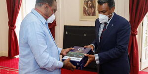 DPP Noordin Haji (right) presents the 2017/2018 and 2018/2019 Performance Report to President Uhuru Kenyatta at State House on Monday, November 9, 2020.