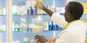 A pharmacist attending to his store 