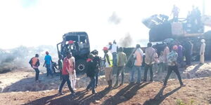 Demonstrators in Isiolo visit a site where a truck and excavator were set ablaze.