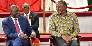 Deputy President William Ruto (left) and President Uhuru Kenyatta enjoy a hearty moment during the BBI launch at the Bomas of Kenya on November 27, 2019.