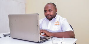 Dominic N. Kimani Principal at Sunrise Homeschooling using a laptop