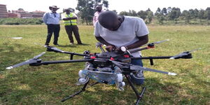 A man operating a drone in Kenya