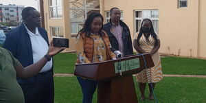 Jubilee aspirant Damaris Waiganjo (centre) flanked by Kiambu Governor James Nyoro (left) and BBI secretariat co-chairman Dennis Waweru addressing the media at Elysian resort, Nairobi.