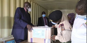 Education CS George Magoha (left) oversees the opening of KCSE examinations