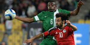 Egypt talisman Mohamed Salah (in red) battles for an aerial ball in a past match against Nigeria 