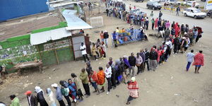 An image of people queuing up to vote 