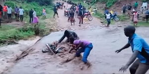 A boda boda rider and his colleague attempt to rescue a motorcycle on Saturday, April 18, 2020, in West Pokot.