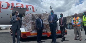 Ethiopia’s Ambassador to Kenya Meles Alem (left), KAA chief executive Alex Gitari (centre) and Kenya’s Director of Health Patrick Amoth receive a donation from Chinese billionaire and Alibaba co-founder Jack Ma at JKIA.