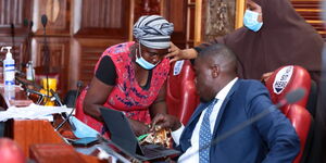 Beatrice Wayeko selling groundnuts to Nairobi Senator Johnson Sakaja on Thursday, March 11 at Parliament building.