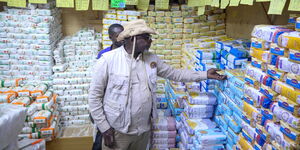 Agriculture CS Mithika Linturi inspecting unga prices at supermarkets on November 23, 2023.