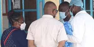 Family and friends of doctor James Gakara consult at the Nakuru level five hospital