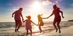 File photo of father, mother and their two kids at the beach