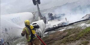 Firefighter at the scene where a plane crash landed in Mogadishu on Monday, July 18, 2022