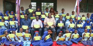 President Uhuru Kenyatta and Deputy President William Ruto and CS Joe Mucheru with pupils of Catholic Primary School in Wajir inspecting the implementation of the Digital Literacy Programme(DLP) on May 20, 2016.