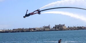 A photo of a person fly-boarding 