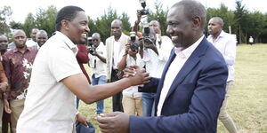  (l) enjoy a hearty moment at Thiru Secondary School, Laikipia West, Laikipia County on February 22, 2020.