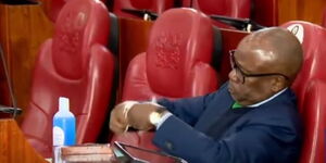 Former Attorney General Githu Muigai checking his face mask during questioning at the Senate on July 22, 2020.