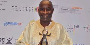 Former KTN Presenter John Sibi-Okumu holds his Lifetime Achievement Award in Tunisia