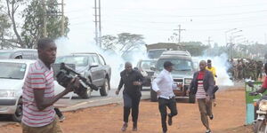 Former Kakamega Senator Boni Khalwale (in black cap) runs from Anti-Riot police officers who stormed a parallel meeting during a rally in Mumias on January 18, 2020.