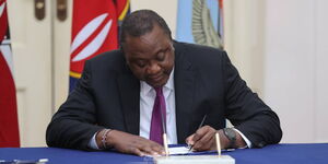 Former President Uhuru Kenyatta signs the Military Veterans Bill into Law in June 2022.