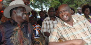 Former Prime Minister Raila Odinga (left) and Busia Governor Sospeter Ojaamong