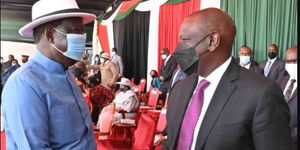 Former Prime Minister Raila Odinga (left) greets Deputy President William Ruto during the Jamhuri Day celebrations on Sunday, December 12, 2021.